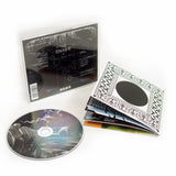 Image of a cd booklet, cd, and the back of a cd case against a white background. The cd and booklet are for tinashe's album "333". the cd is grey and white with abstract imagery. The back of the booklet is black and white- there is a black solid circle in the center surrounded by the 333 logo and other abstract imagery in the shape of a square. The back of the case says tinashe and lists the track list in white and has a faded 333 logo behind the lettering.
