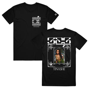 Photo of front and back of the black Tinashe 333 Tee shirt. Front has white flower pattern and "Tinashe" on left chest area. Back has "333 logo and "Tinashe" in white and features a color print of Tinashe wearing a revealing gold outfit.