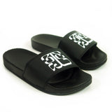 Image of black slide sandals against a white background. The middle of the strap on the slides feature the tinashe 333 logo in white. The logo is a 3 facing the right way, mirrored by a 3 facing the opposite way, connected to a large 3 that is sideways and across the bottom of the other two 3's, forming a square shaped logo.