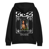 Photo of the back of the black Tinashe 333 hooded sweatshirt. Back has "333 logo and "Tinashe" in white and features a color print of Tinashe wearing a revealing gold outfit.