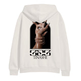 Image of the back of a bone colored hoodie against a white background. The back of the hoodie features an image of a hand with long nails and an eye in the center of the palm. Another hand with long nails grips around the wrist of the hand with the eye. Below this in black says "333" and below that in says "tinashe".