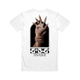 Image of the back of a white tshirt against a white background. The back of the tshirt features an image of a hand with long nails, and an eye in the center of the palm. Another hand with long nails grips around the wrist of the hand with the eye. Below this in black says "333" and below that in says "tinashe".