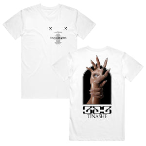 Image of the front and back of a white tshirt against a white background. The left chest features two small black checkerboard designs. Below in black is the track listing to tinashe's album "333". over top of the words in black text reads "tinashe 333". The back of the tshirt features an image of a hand with long nails, and an eye in the center of the palm. Another hand with long nails grips around the wrist of the hand with the eye. Below this in black says "333" and below that in says "tinashe".