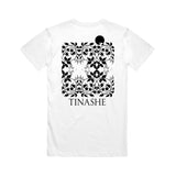 Image of the back of a white tshirt against a white background. the back of the shirt features a pixelated abstract flowery design in black and in the shape of a square. Below this in black text reads "tinashe".