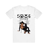 Image of the front of a white tshirt against a white background. The front of the tee in black text across the chest reads 333. below that says tinashe. below that in small black text is the track listing to the album 333. There is an image of tinashe posing in a black outfit on the ground against the white color of the tshirt.