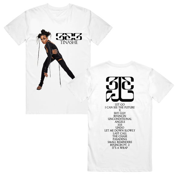 Image of the front and back of a white tshirt against a white background. The left side of the shirt features an image of tinashe standing in a black outfit striking a pose. Next to her in black text reads 