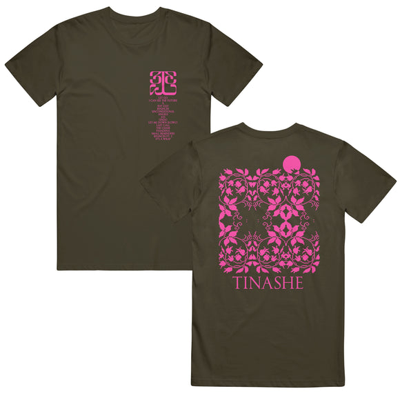 Image of the front and back of a hunter green tshirt against a white background. The front of the tee on the left chest in pink features the 333 logo and below that lists the tracklist to tinashe's album 333. the back of the shirt features a pixelated abstract flowery design in pink and in the shape of a square. Below this in pink text reads 