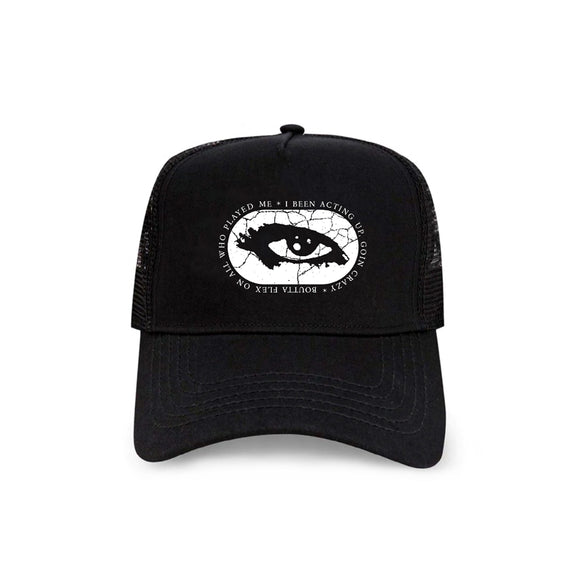 image of a black trucker mesh hat on a white background. hat has small embroidery on the front and center of a white eye in a cracked oval with the words i've been acting up, goin crazy, boutta flex on all who played me around the outside of the oval
