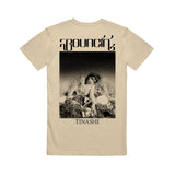 Image of the back of an oatmeal colored tshirt against a white background. The back of the tee says "bouncin'" across the shoulder area in black. Below that is a rectangle and inside of the rectangle is a photo of tinashe sitting down, looking at the camera. Below this in black text reads "tinashe".