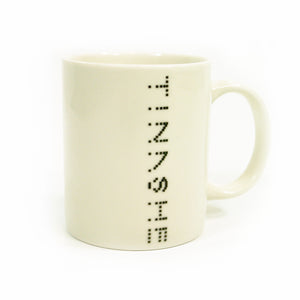 Image of a white coffee mug against a white background. Descending down the mug in black dotted text reads "tinashe".